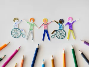 A drawing of wheelchair users and non-wheelchair users holding hands.